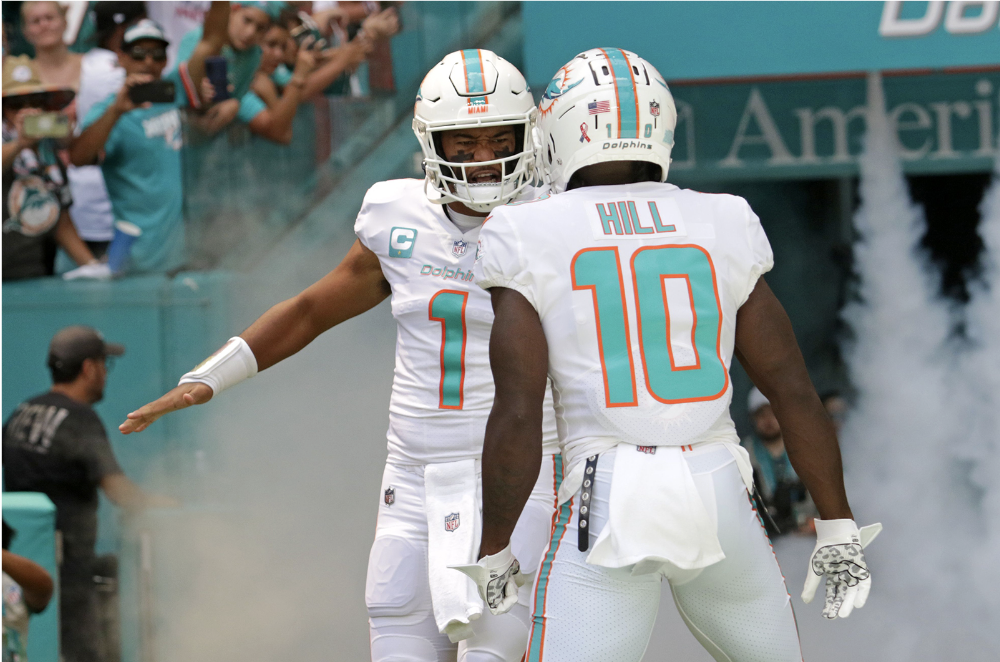 Miami Dolphins quarterback Tua Tagovailoa and wide receiver Tyreek Hill take the field for their game against the New England Patriots at Hard Rock Stadium on Sunday in Miami Gardens. (John McCall/Sun Sentinel/TNS)